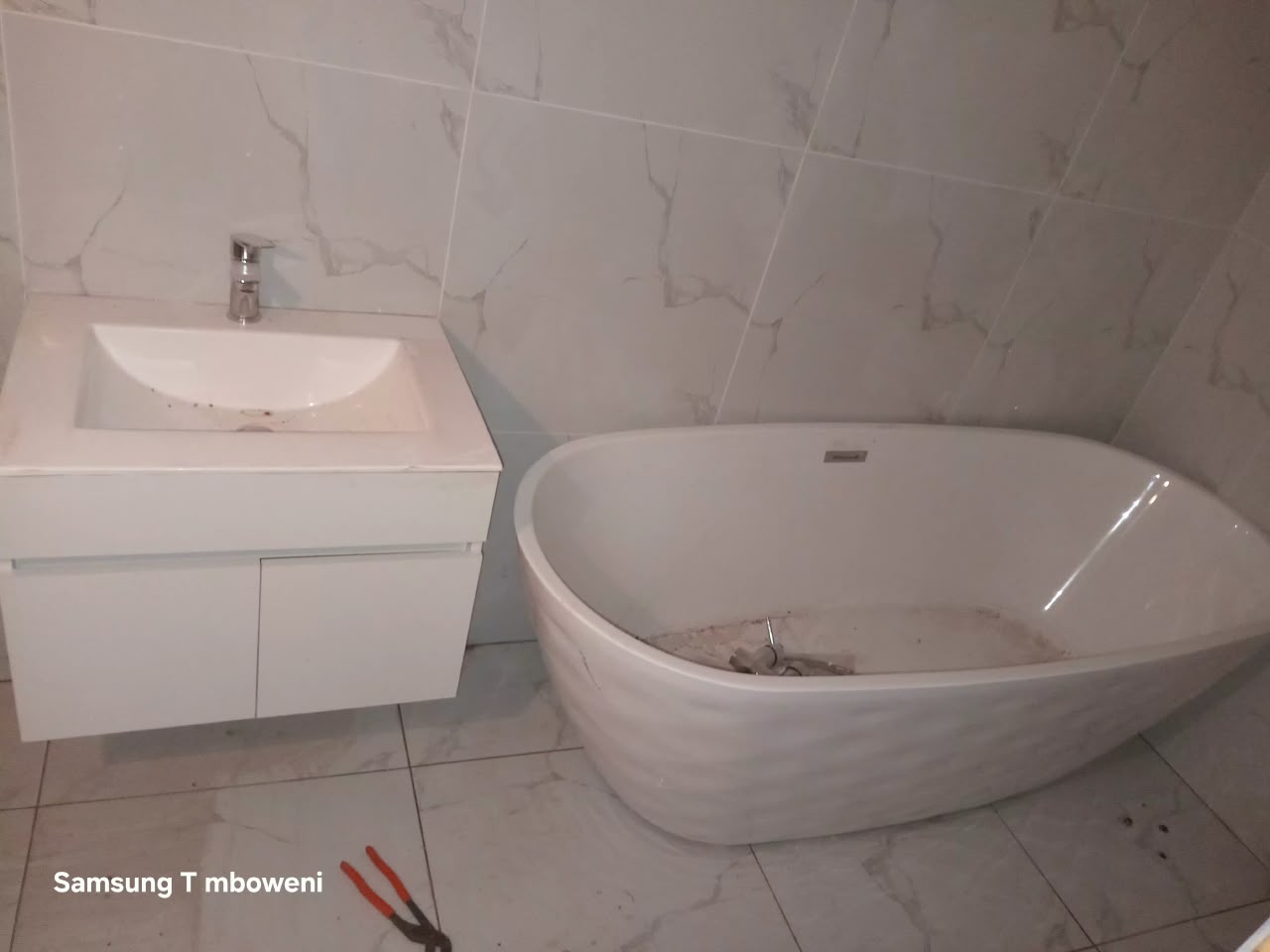 Completed bathroom renovation with new tiling and fittings by Best Choice Renovation
